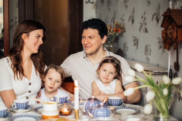 A warm family gathering celebrating a traditional Russian holiday indoors with festive food and decor.